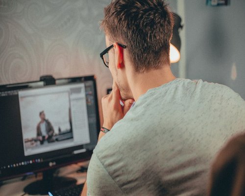 Person looking away from a computer screen to rest their eyes during work